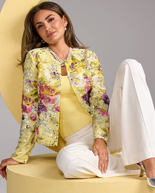 Models wearing a yellow tank top, white pants and a yellow embellished jacket.