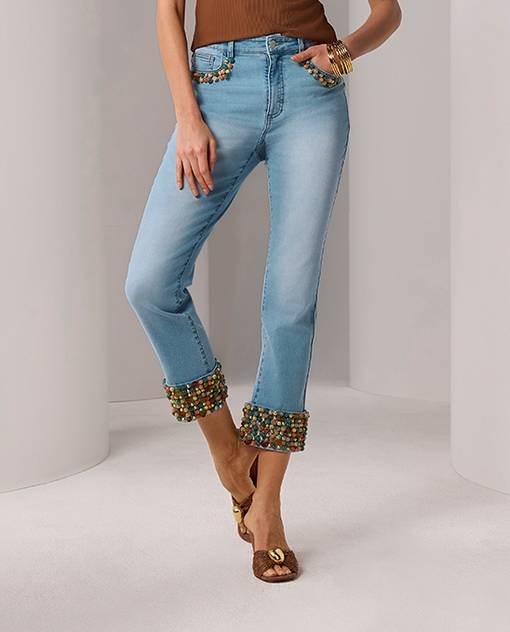 Models wearing light wash denim with embellishements.