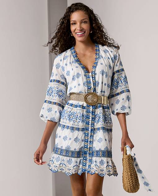 Models wearing a blue and white dress with straw belt.