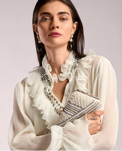 model wears cream long sleeve blouse