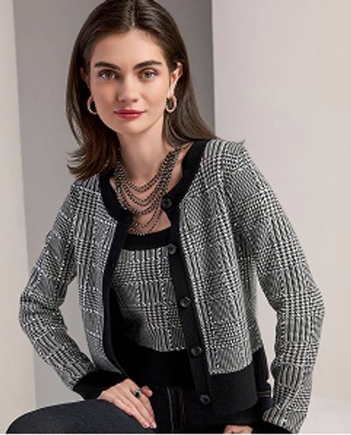 Models wearing a black and white sweater and matching cardigan.