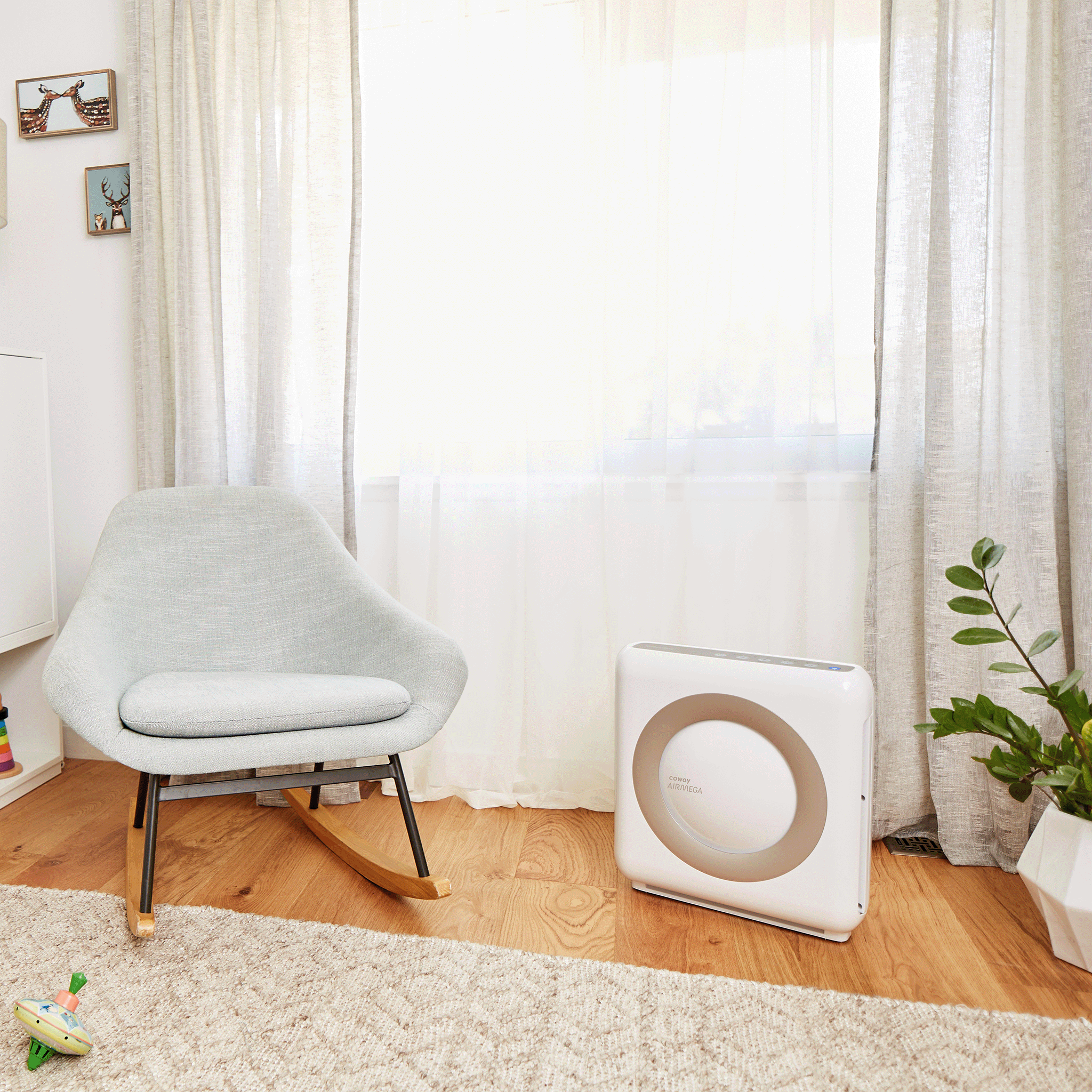 Coway Airmega AP-1512HH in White, placed in a nursery room next to a chair