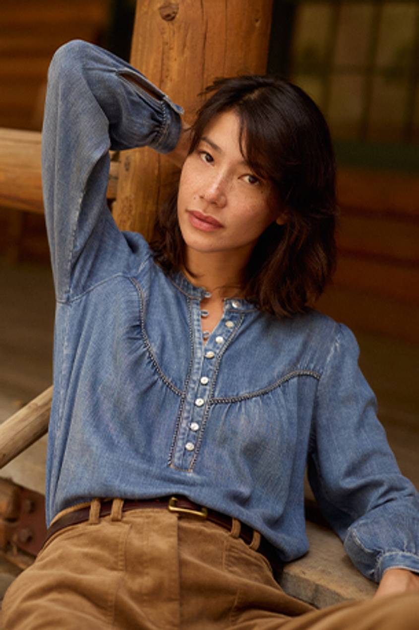 Media Card with Medium Wash Denim Top, Camel Corduroy Pants and Mini Remi Belt in Brown Gold. Sitting Close Up Top View Featured on Model.