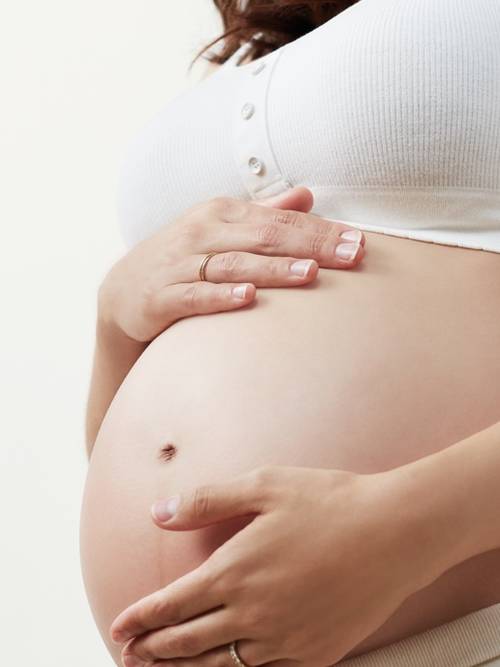 Pregnant woman holding belly