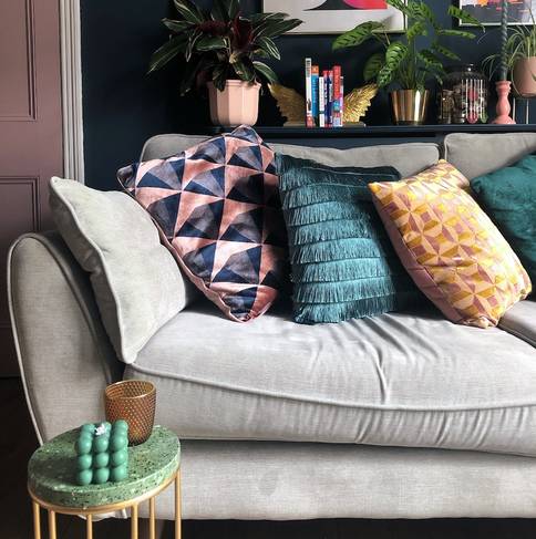 selection of colourful cushions on a grey sofa