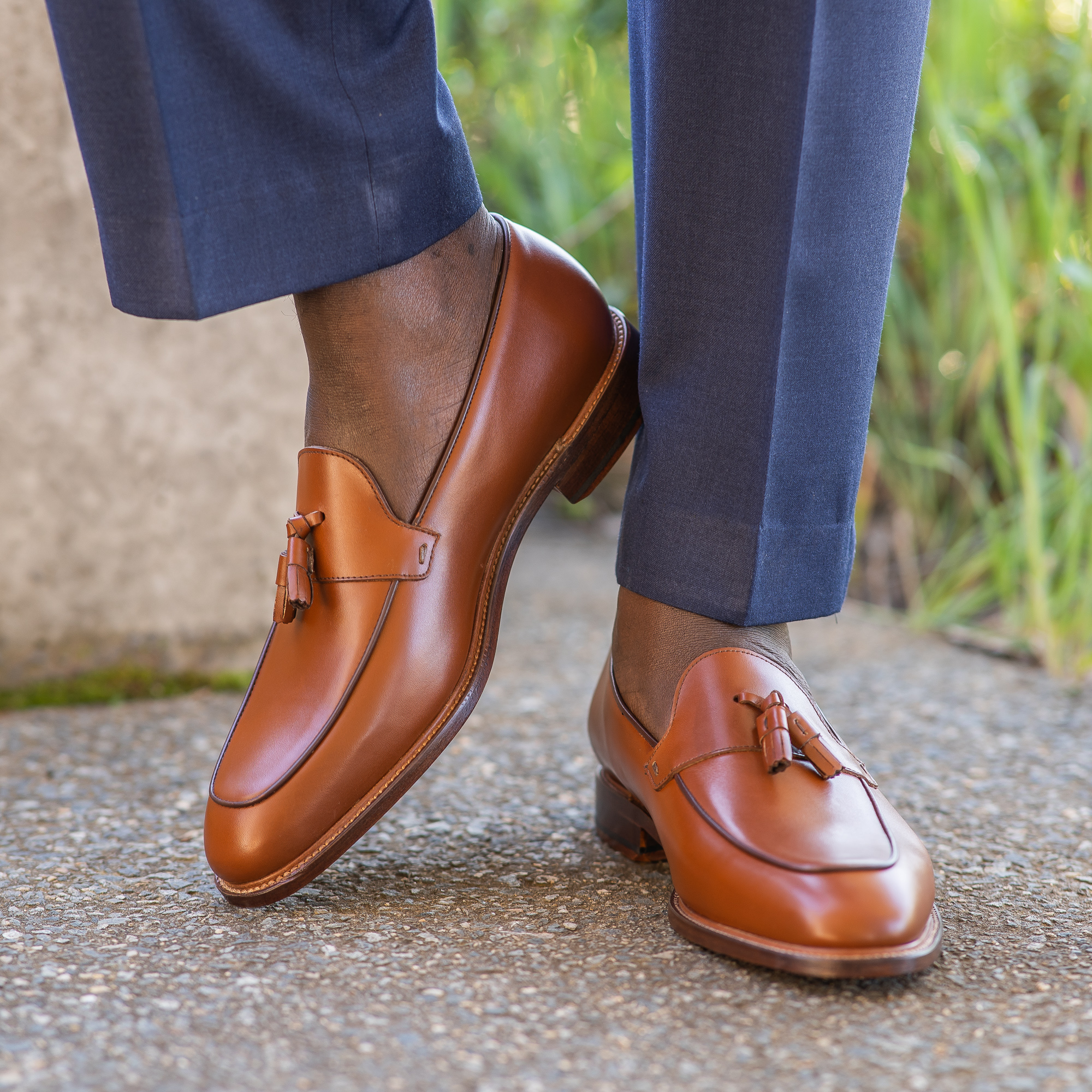 Tan loafers paired with tailored suit. Best casual loafers for men