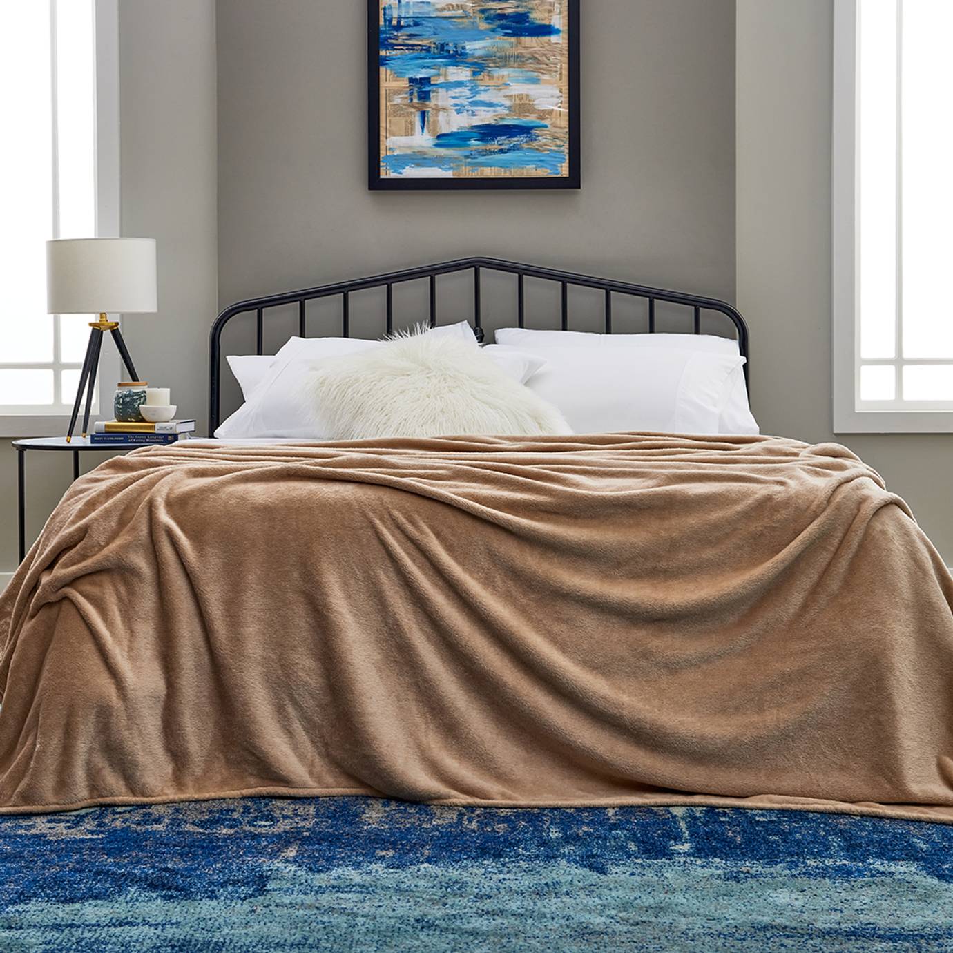 A cozy bed dressed in Cosy House Collection bedding.