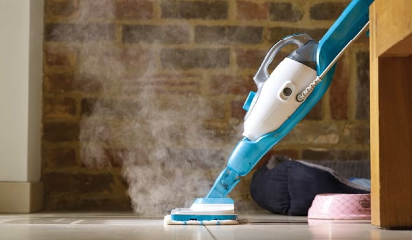 7 in 1 Steam Mop with steamglove handheld steamer being used to clean floor.