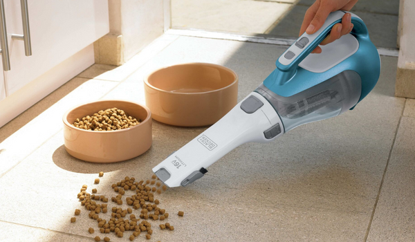 Dustbuster cordless hand vacuum being used by a person.