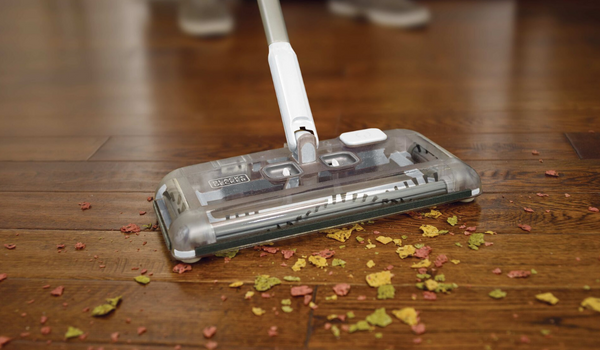 sweeper picking up food debris on hard surface