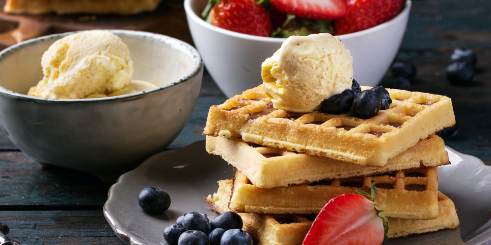 Waffles on a plate with butter and berries