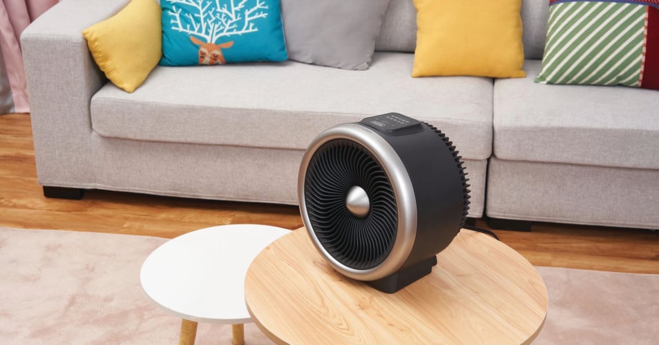 Digital turbo portable heater fan combo 2 in 1 electric personal mini space heater on a wooden table in living area.