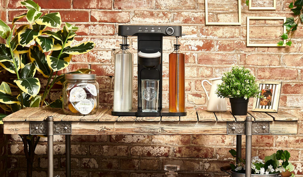 bev by BLACK+DECKER(TM) cocktail maker sitting on a farmhouse rustic bar cart