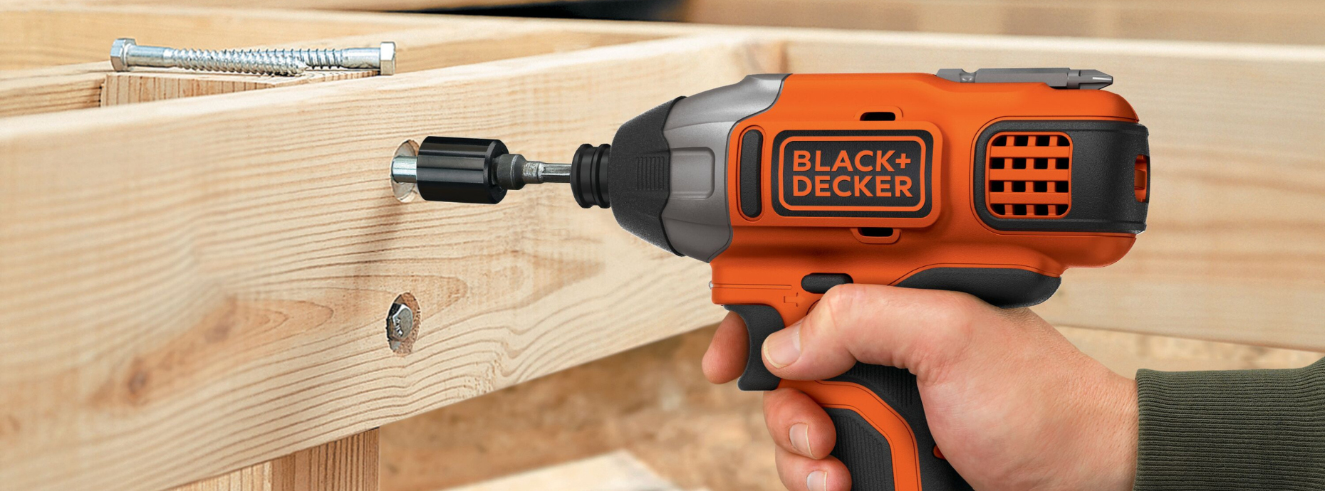 Person using BLACK+DECKER impact driver to bore a hole in a piece of wood