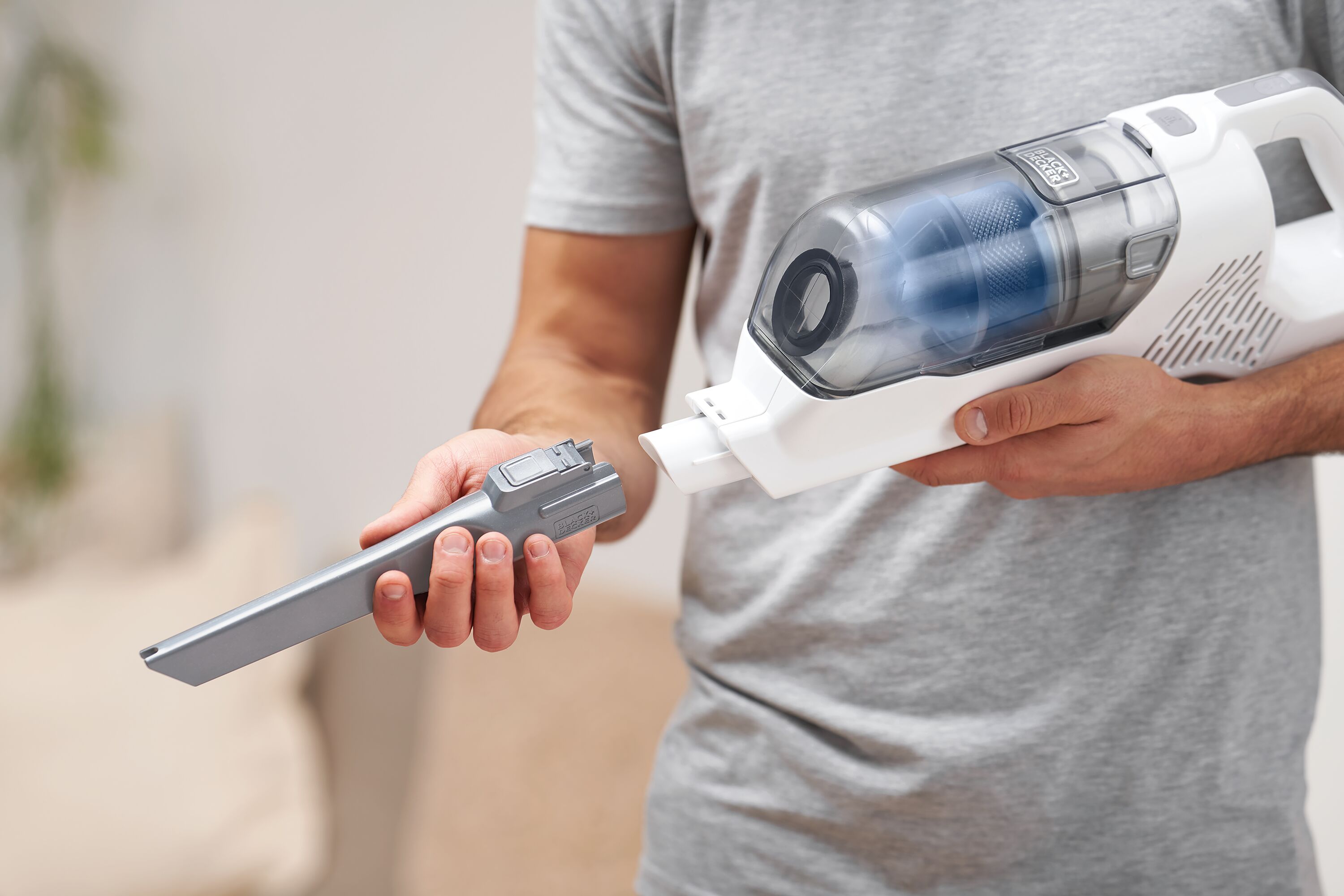 Student getting ready to clean dorm room with BLACK+DECKER hand vacuum