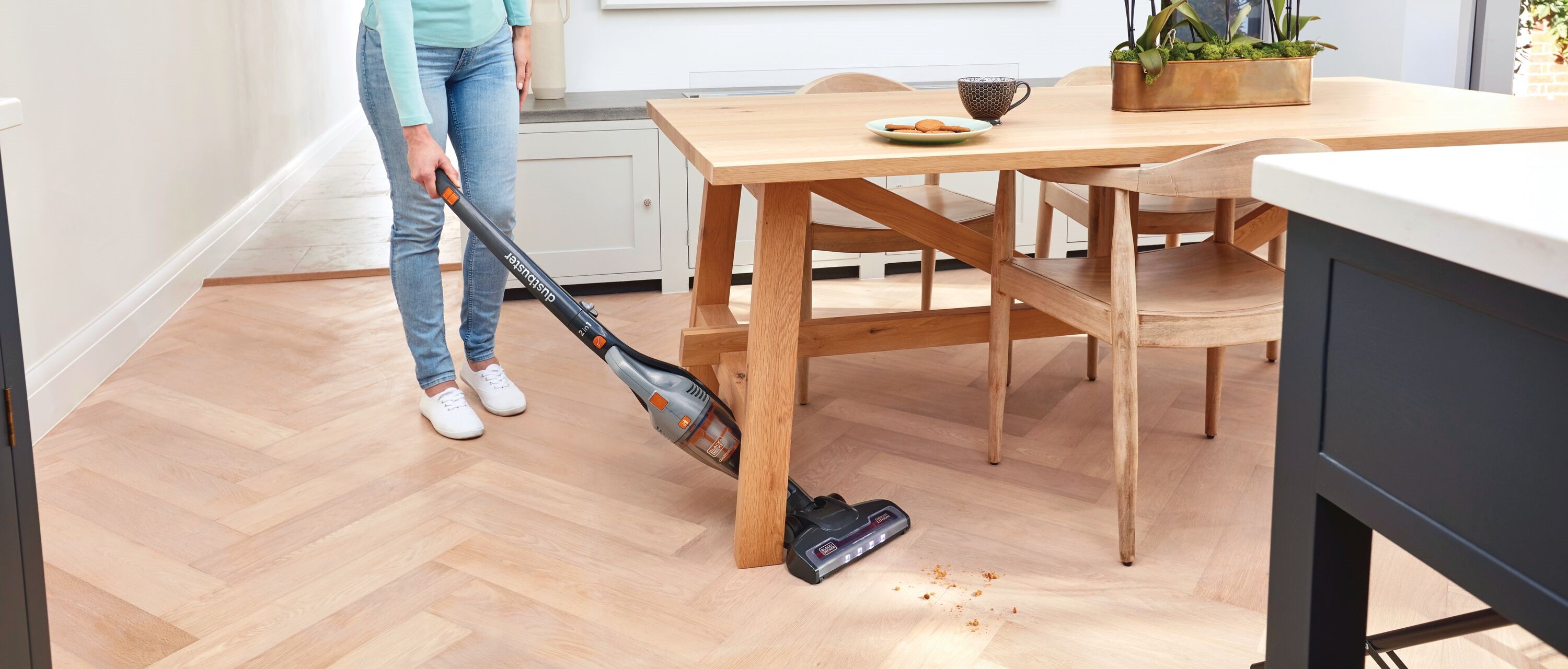 Powerseries 2 in 1 cordless stick vacuum being used by a person.