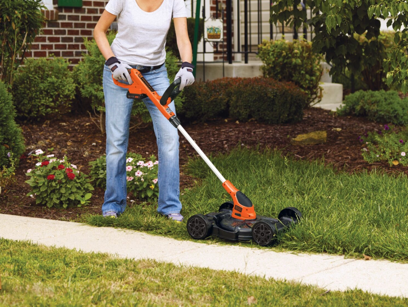 Woman using 3 in 1 string trimmer, mower, edger