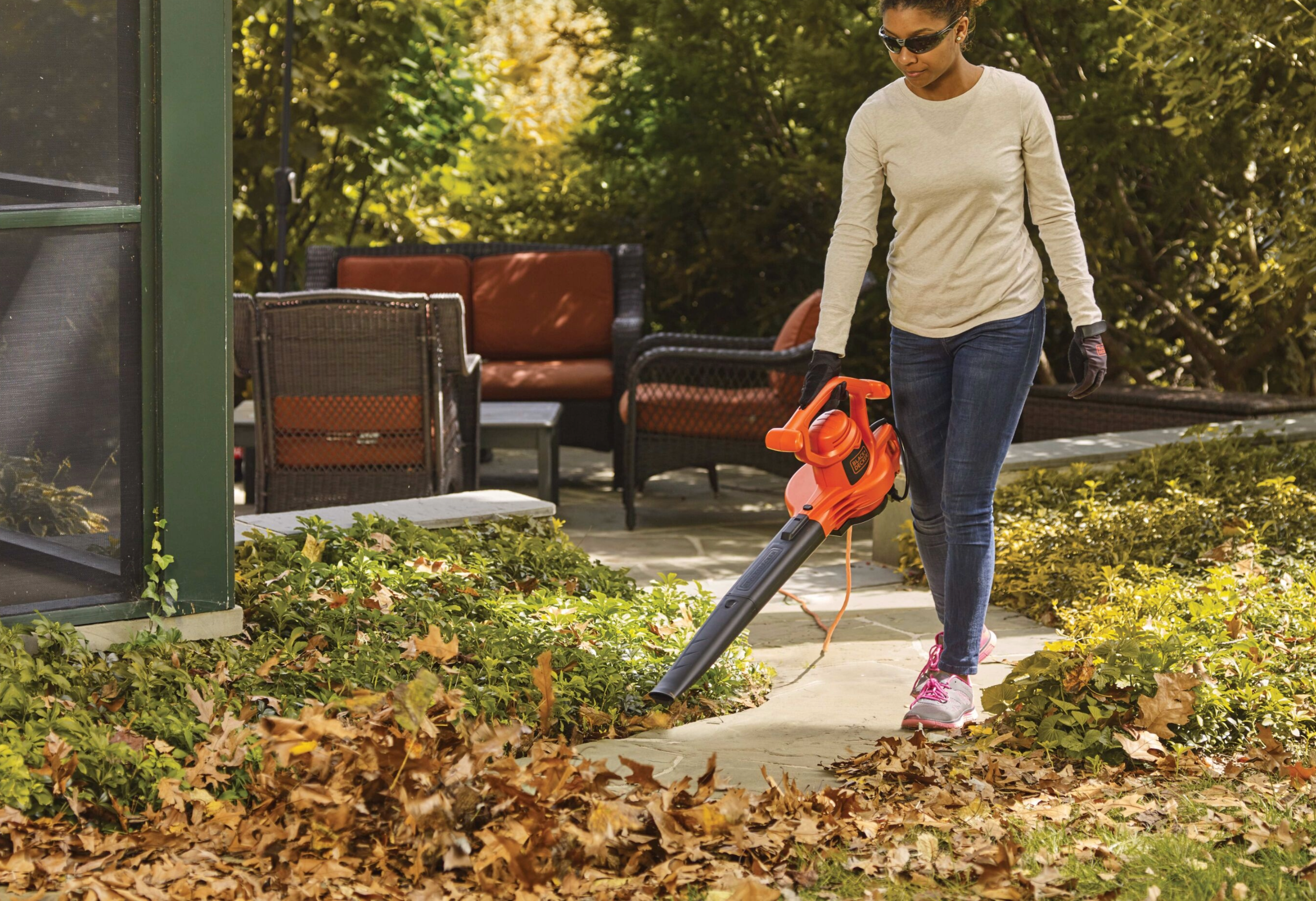 woman using leaf blower