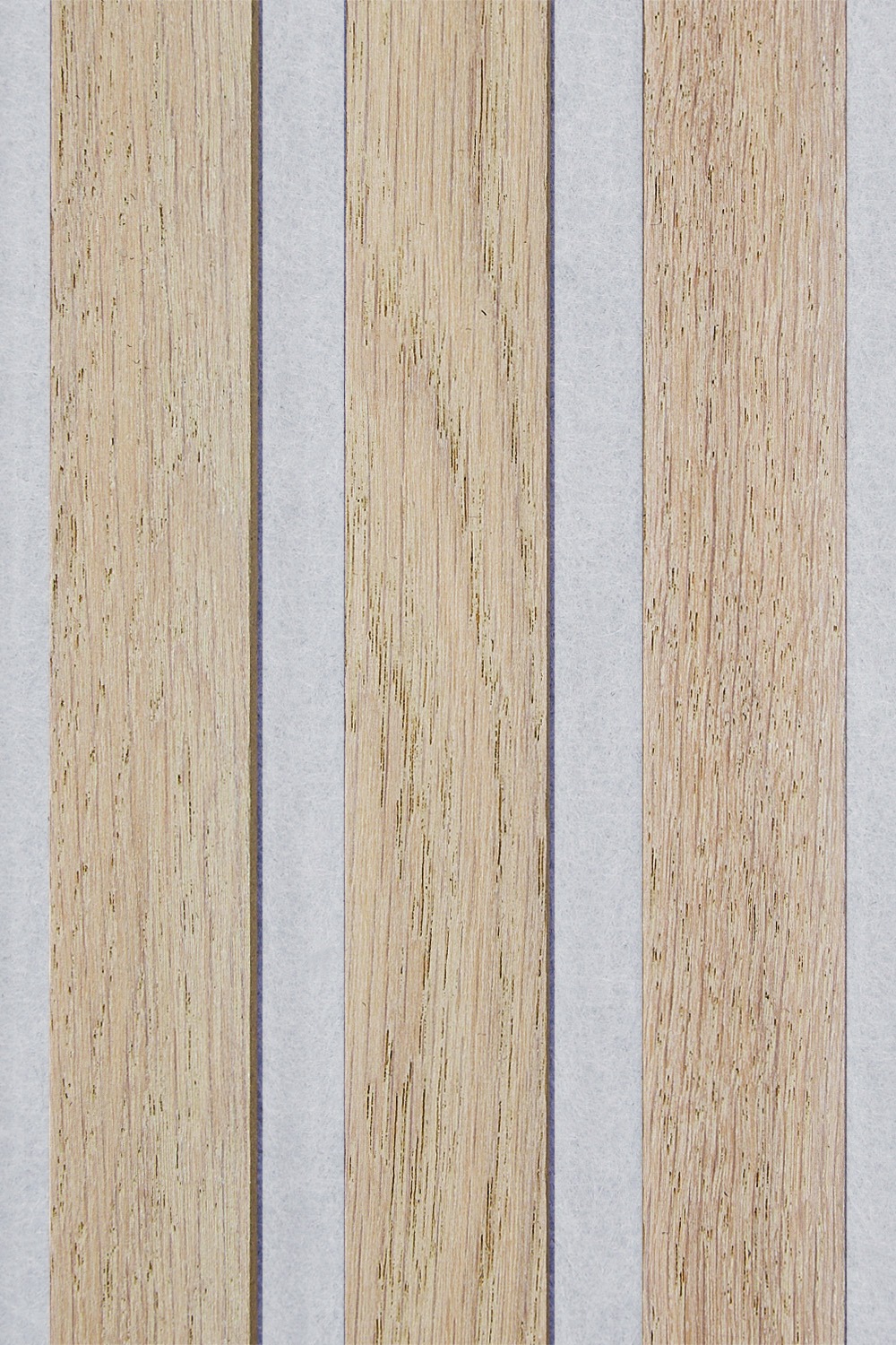 Close up of a SlatWall Washed Oak panel. Shows three veneered slats and grey felt backing.
