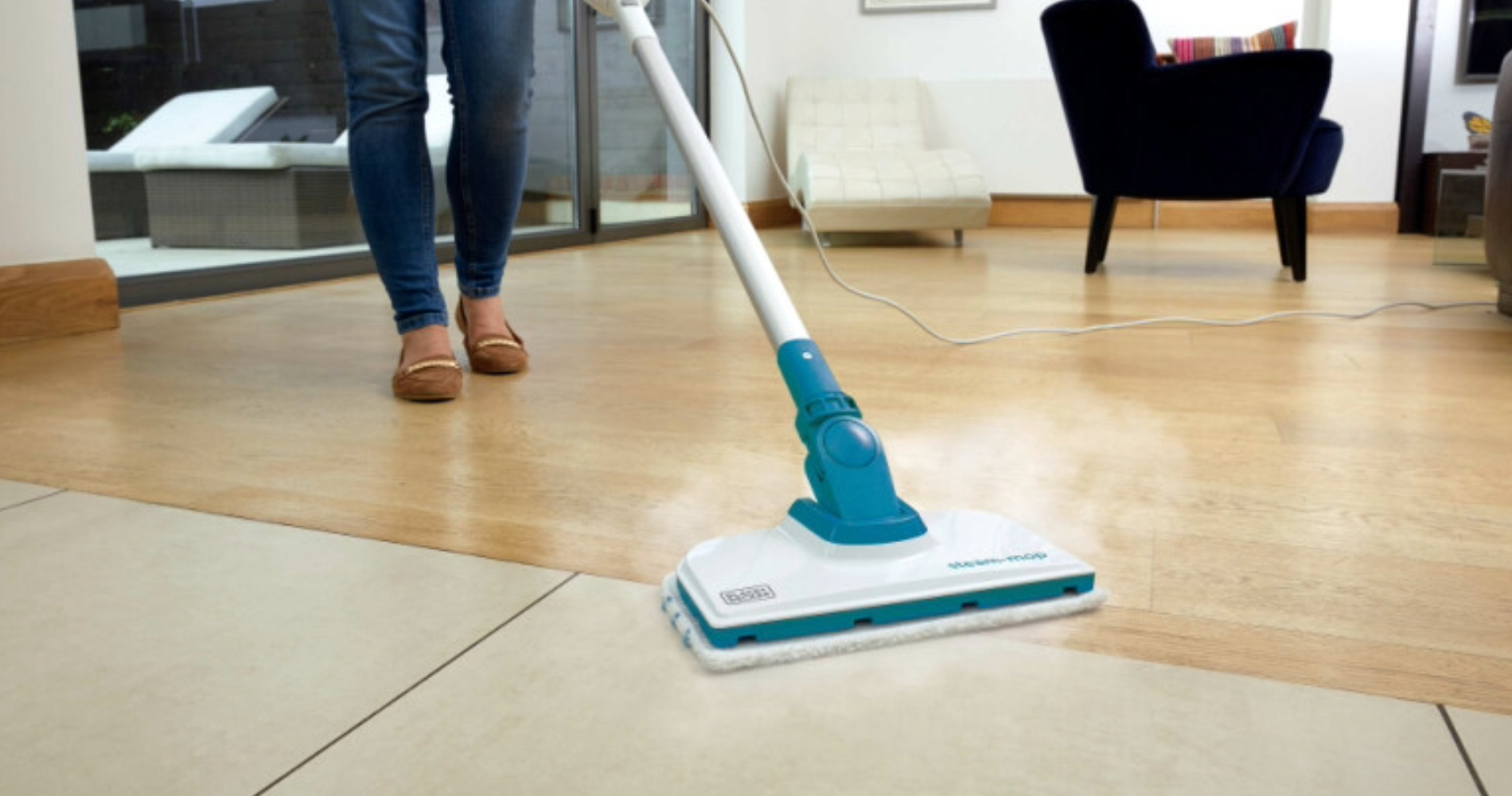 Woman using steam mop on tile floor