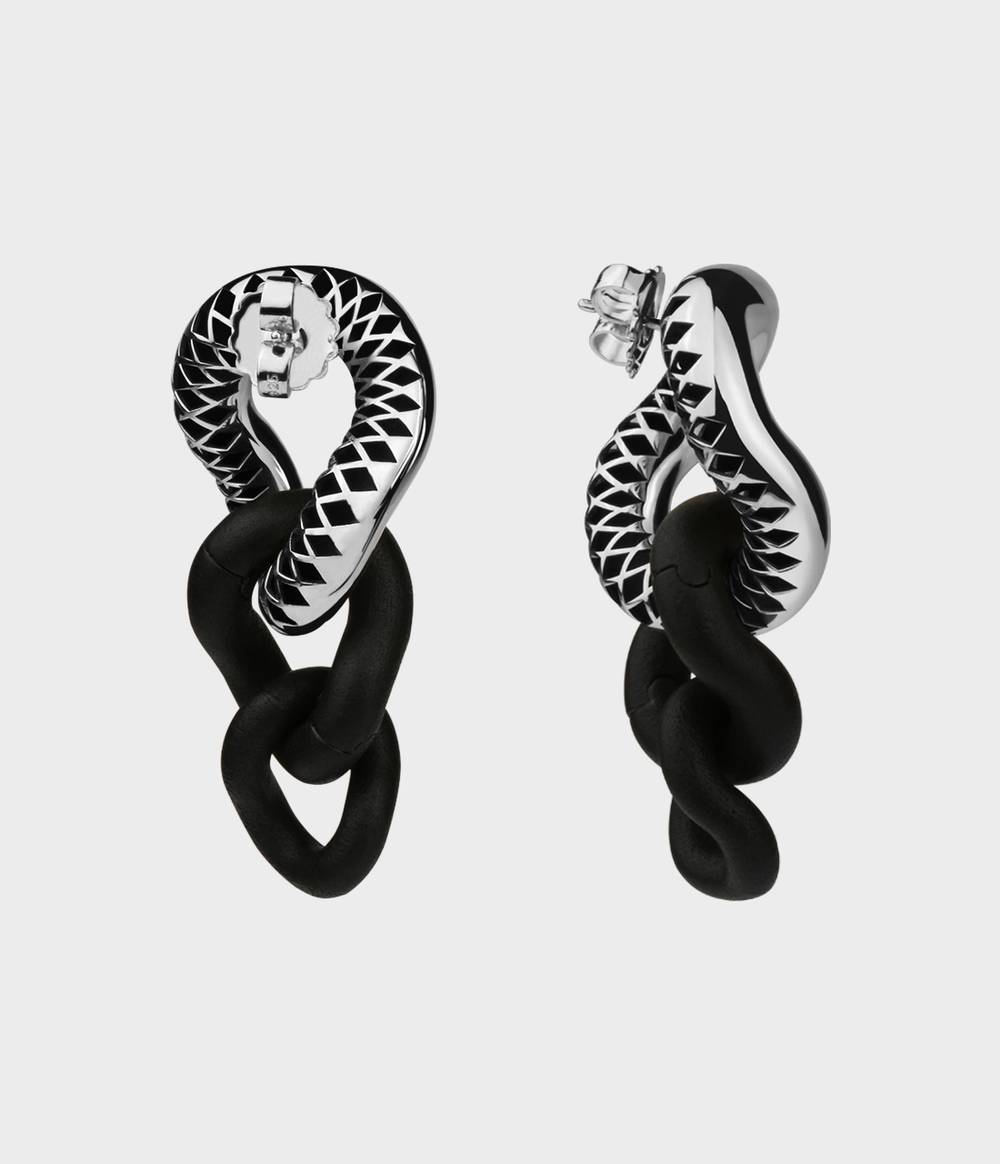 Back and side view of a pair of silver and black caster seed drop earrings.