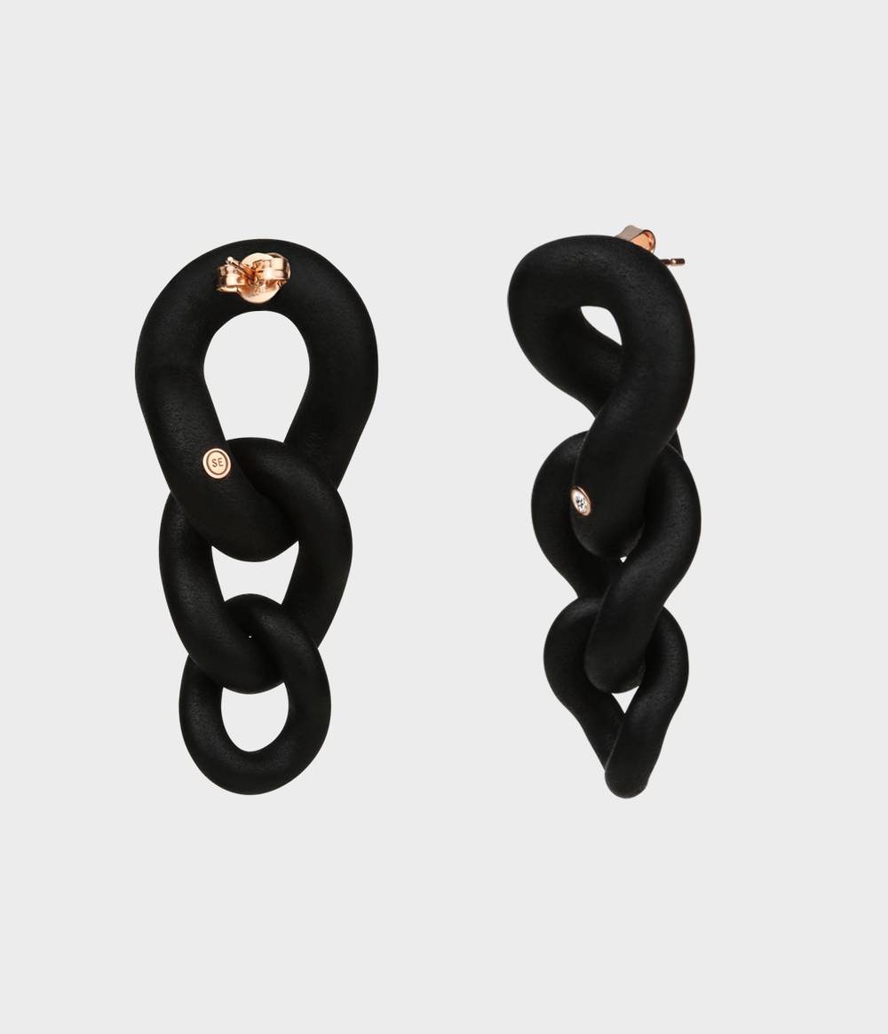 Back and side view of a pair of black caster seed earrings with one diamond set on rose gold collets, one on each earring from the Raven jewellery collection.