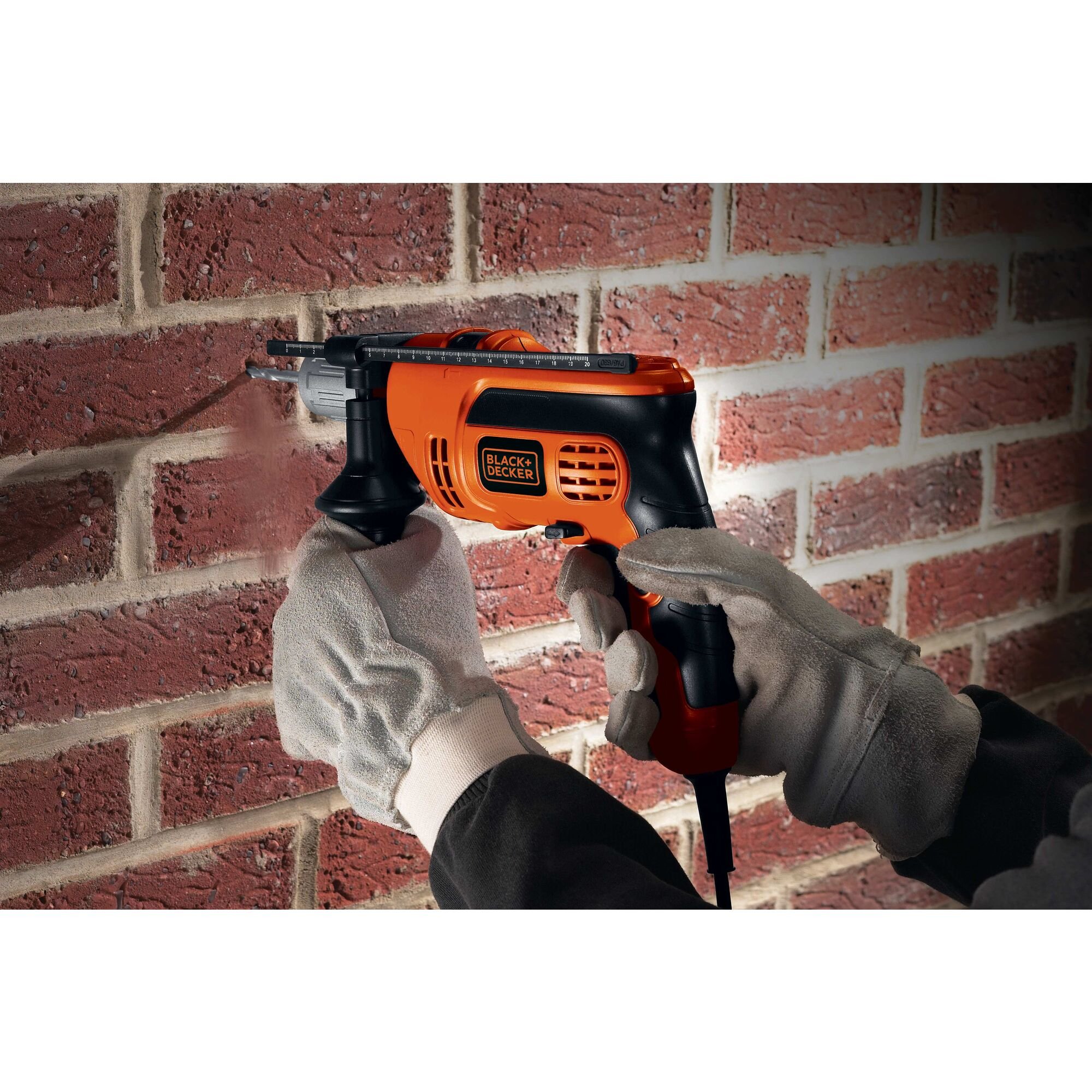 Hammer drill being used on a brick wall