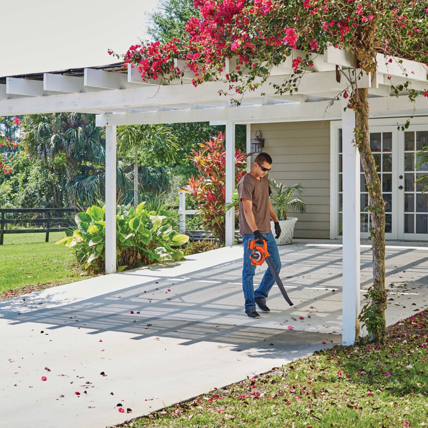 Man using leaf blower on covered patio