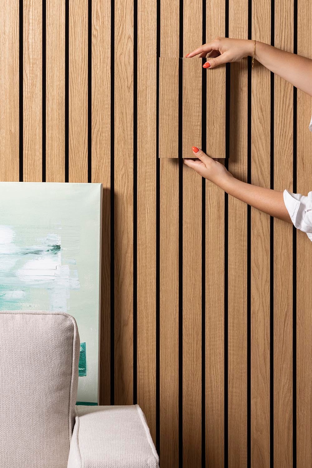 Oiled Oak Slatwall Grand sample held in comparison against Oiled Oak Slatwall Grand wall.