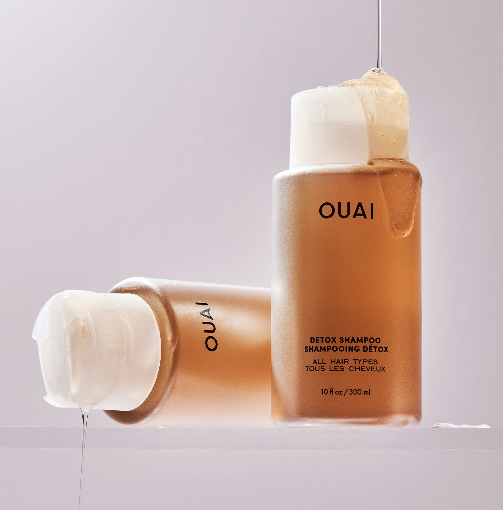 OUAI detox shampoo bottle with pump on a light gray background