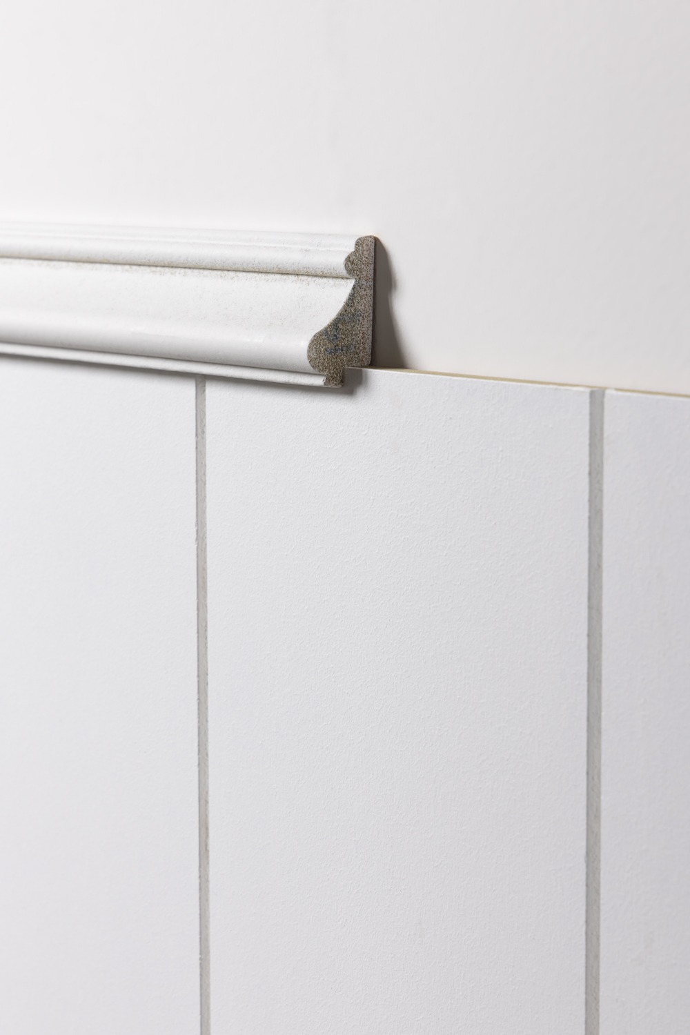 photo of a white dado rail being used as a top trip on wall panelling