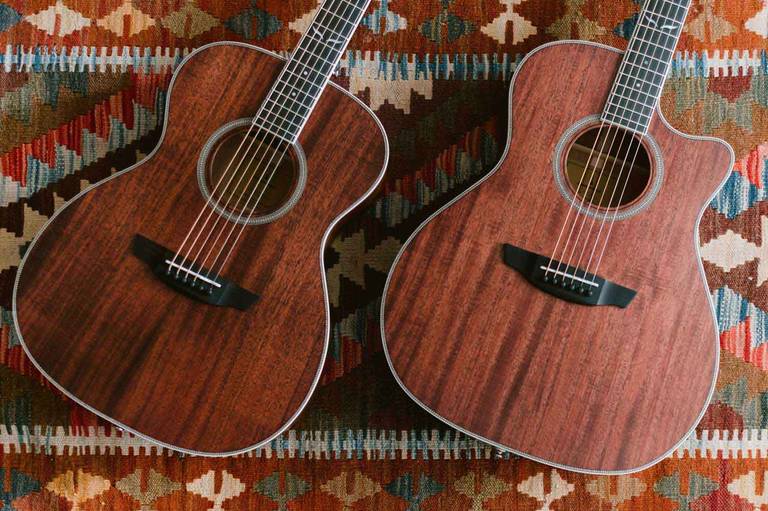 Ava Mahogany and Sage Mahogany guitars lying on a rug