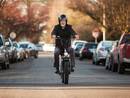 Man riding RadRunner Plus Electric Utility Bike through town