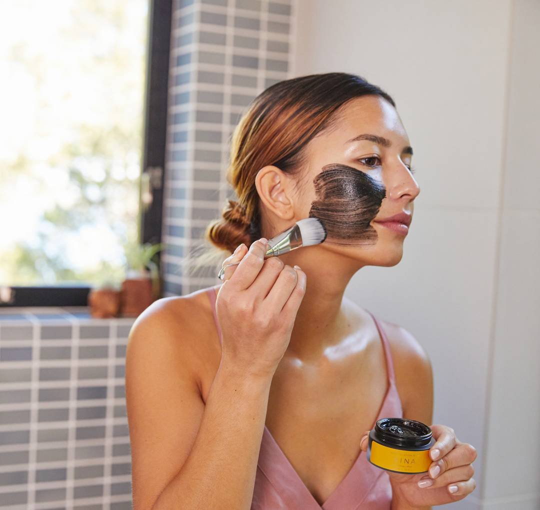 Women applying anti-pollution mask.