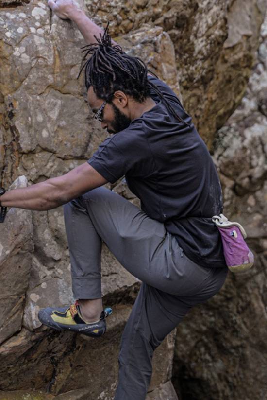 Man rock climbing and wearing the Tordra S.S. Crew by Beyond Clothing.