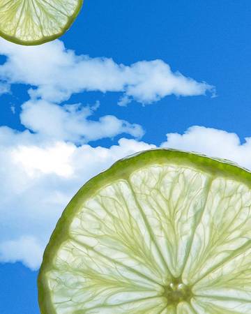  sliced limes with a blue sky background