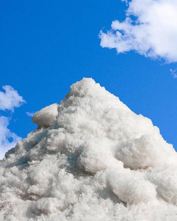  a pile of sea salt and a blue sky background