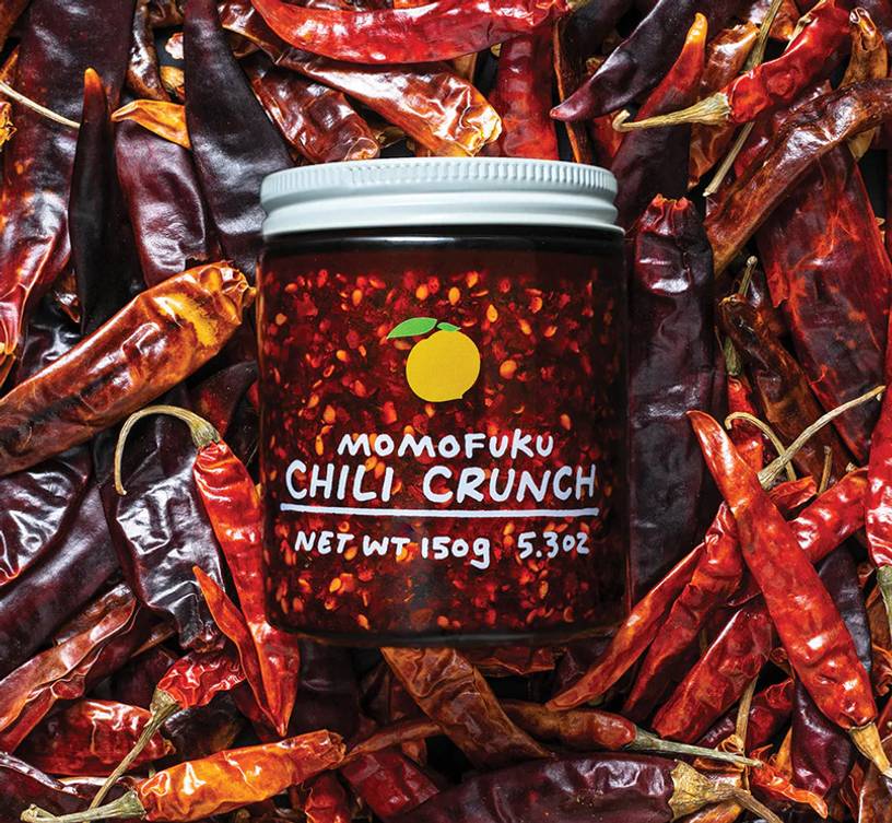 Jar of chili crunch on a bed of chilis