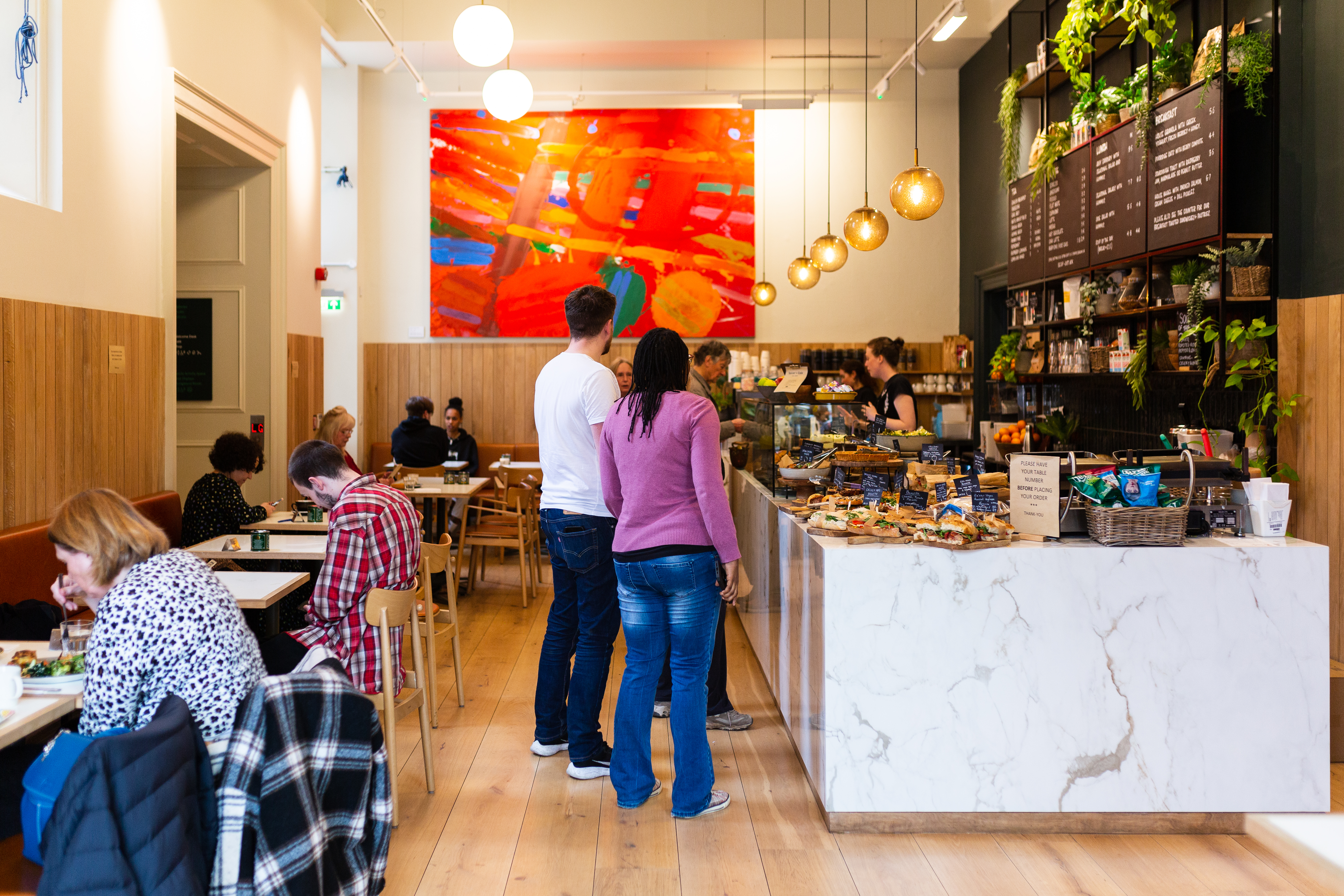 The cafe in the RWA building with a large food counter and seating 