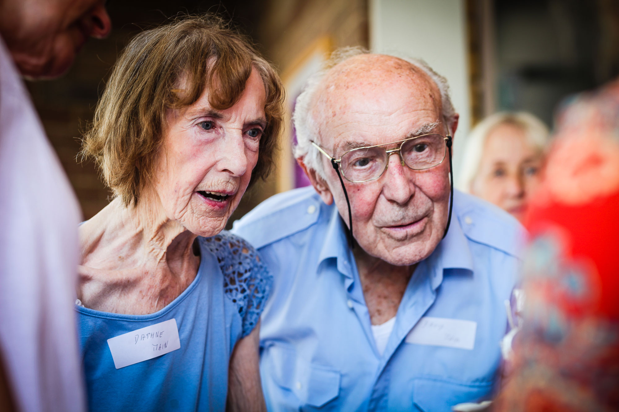 An image of an older man and woman looking at a sculpture in the foreground 