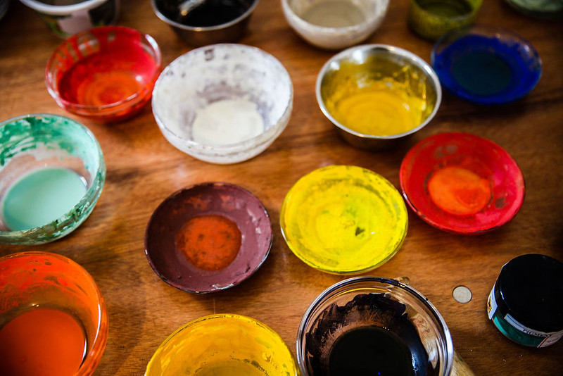 Colour pigments for painting in bowls on a table 
