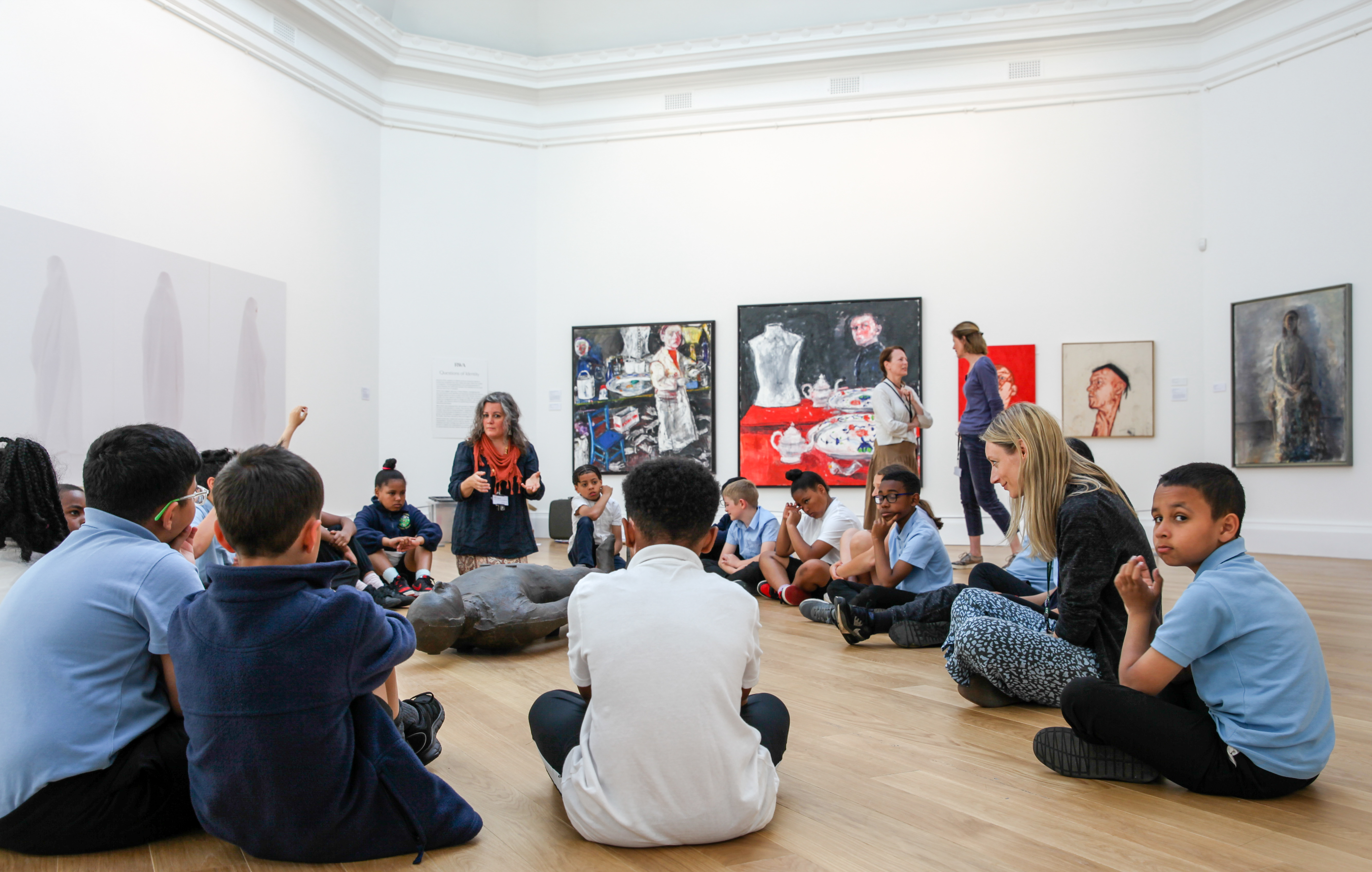 An image of a group of children sat in a circle in the gallery space 