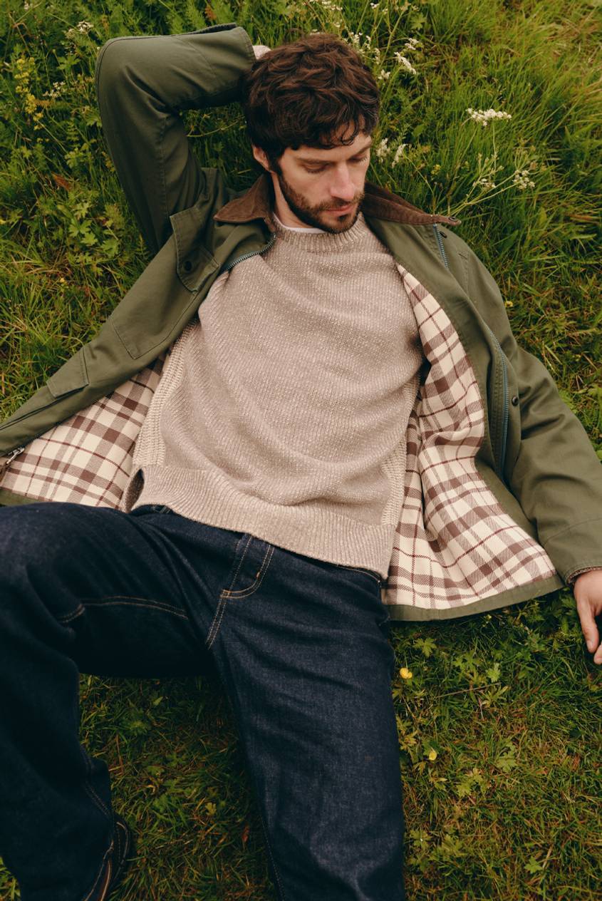Huntly Jacket in Olive shown on a model to showcase the plaid lining, corduroy collar, zip-front design, and relaxed fit. Full Body View Featured on Model.