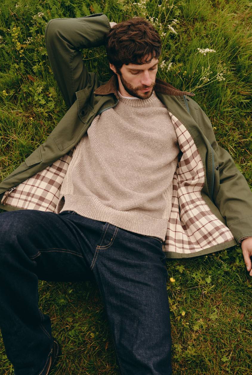 Huntly Jacket in Olive shown on a model to showcase the plaid lining, corduroy collar, zip-front design, and relaxed fit. Full Body View Featured on Model.