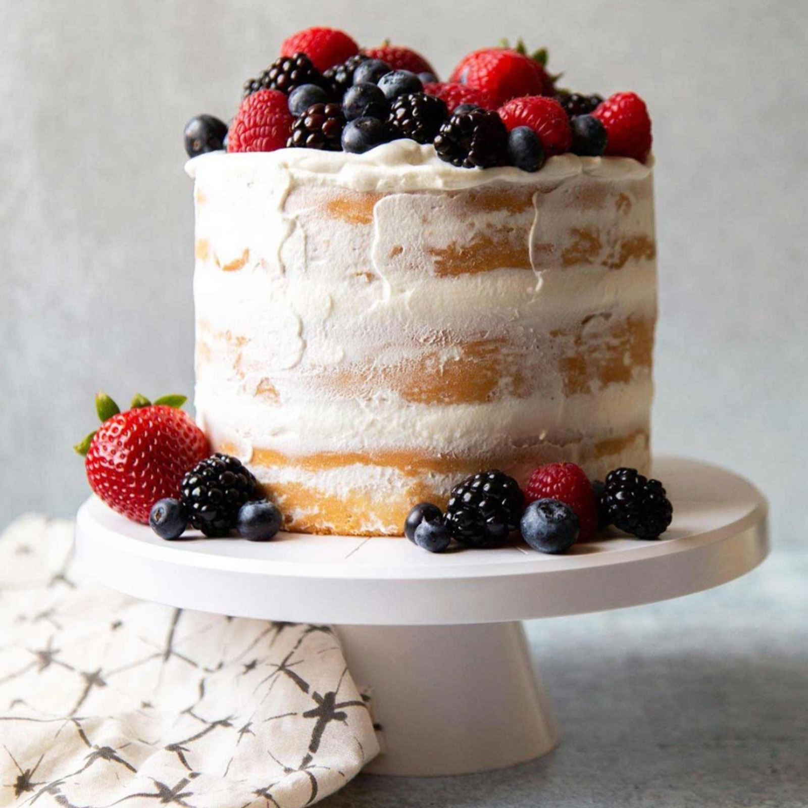 Coconut Cake with Whipped Cream and Fresh Berries by Maryanne Cabrera.
