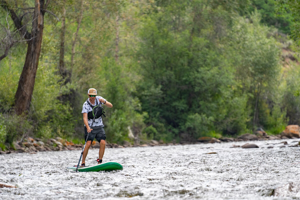 Paddle boarding on a fast flowing river