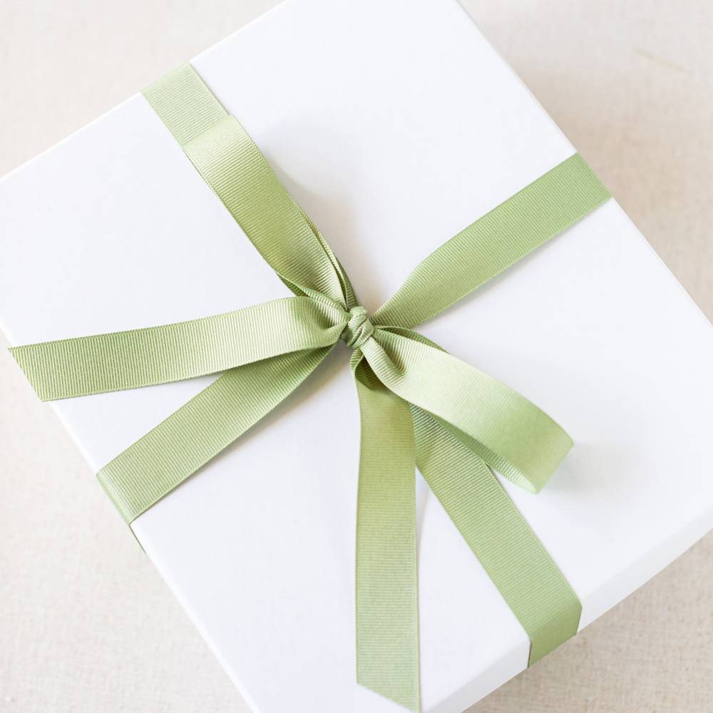 white gift box tied with light green ribbon
