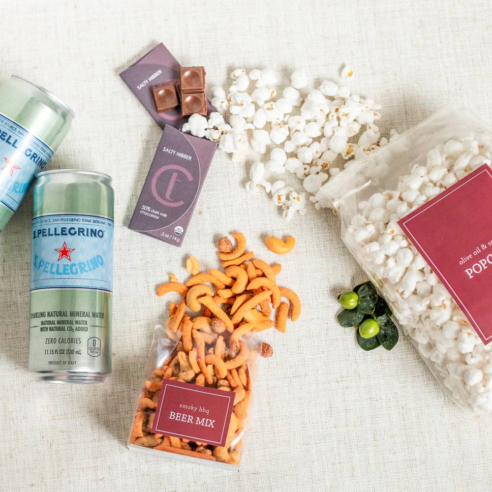 gift box with beer mix, San Pellegrino cans, popcorn, and chocolate bars