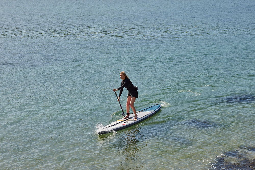 Woman Paddle Boarding at sea on an Elite 12ft 06inch Paddle Board