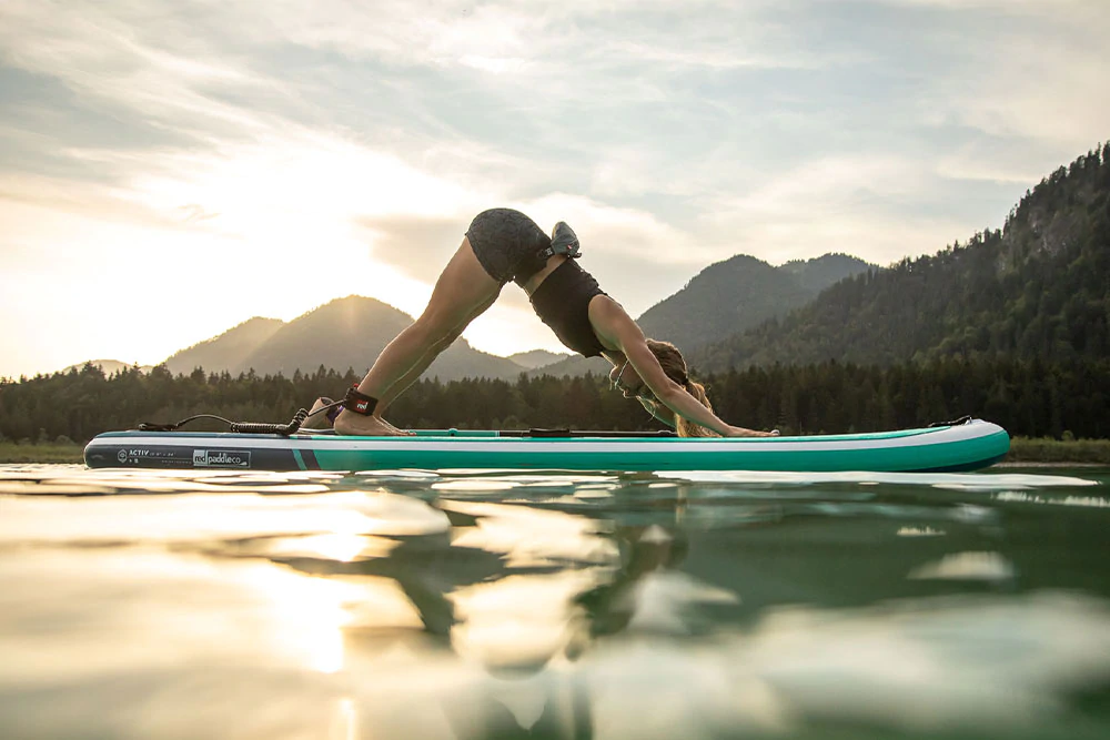 woman doing a plank on her paddleboard.
